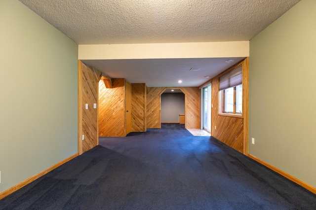 14500 Raleigh Ave, Savage, MN 55378 - unfurnished room featuring wooden walls, carpet floors, and a textured ceiling