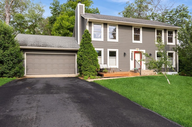 14500 Raleigh Ave, Savage, MN 55378 - colonial house featuring a chimney, driveway, a garage, and a front yard