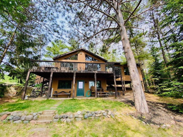 N14220 Island View Rd, Minong, WI 54859 - rear view of property featuring a wooden deck, stairs, a patio area, and a yard