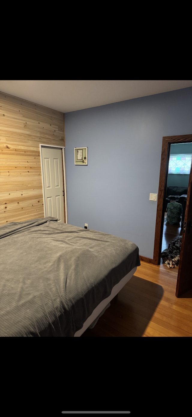60 Main St, Kimball, MN 55353 - bedroom featuring wooden walls and light wood-style flooring