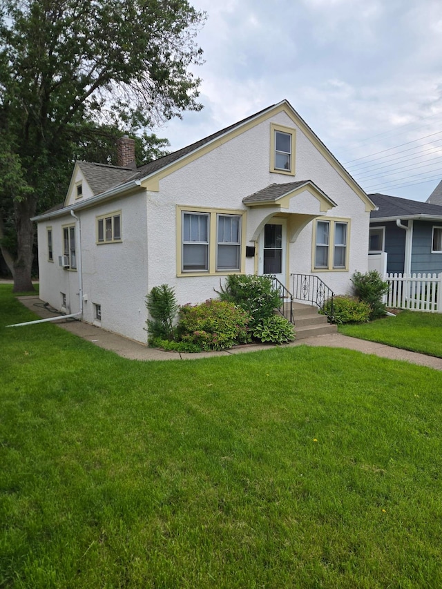 2742 Grand St NE, Minneapolis, MN 55418 - bungalow-style home with a chimney, stucco siding, and cooling unit