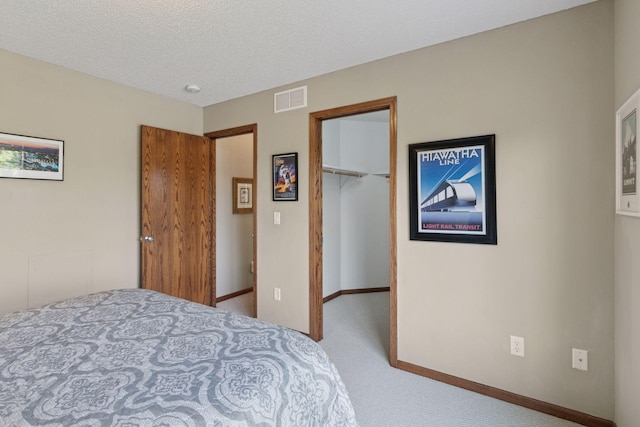 14896 Brenner Ct, Rosemount, MN 55068 - carpeted bedroom with a walk in closet, a closet, and a textured ceiling