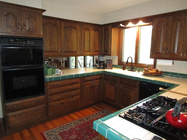 4523 Waville Rd NE, Bemidji, MN 56601 - kitchen featuring black appliances, tile countertops, and wood finished floors
