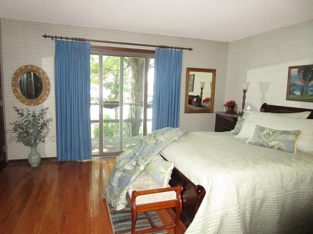 4523 Waville Rd NE, Bemidji, MN 56601 - bedroom featuring wallpapered walls, wood finished floors, and access to exterior