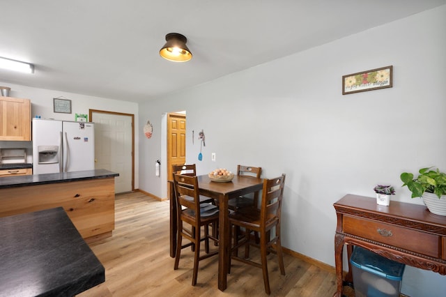 8241 120th St, Bogus Brook Twp, MN 56353 - dining room featuring light wood-style floors and baseboards