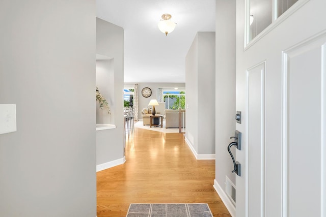 entryway featuring light wood-type flooring and baseboards