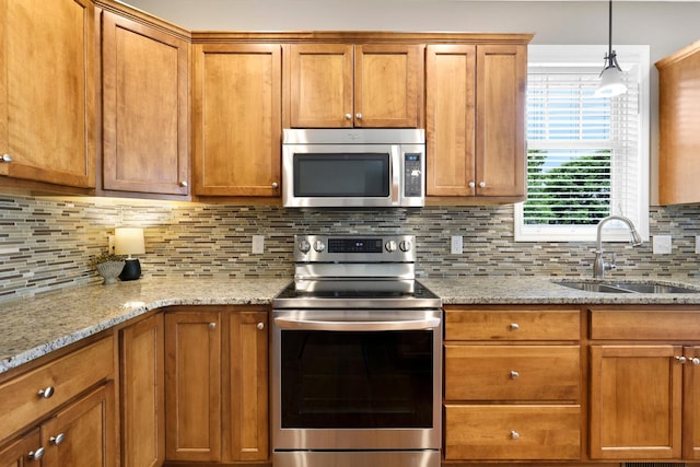 kitchen with stainless steel appliances, brown cabinets, and tasteful backsplash