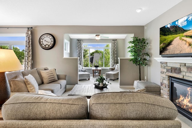 carpeted living room with a fireplace and ceiling fan