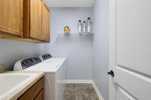 laundry area featuring independent washer and dryer and cabinet space