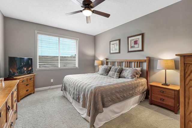 bedroom featuring light colored carpet and ceiling fan