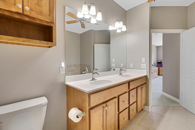 full bath with double vanity, ceiling fan, and tile patterned floors