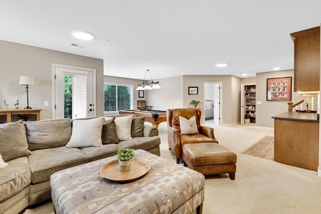 living room with recessed lighting and light colored carpet