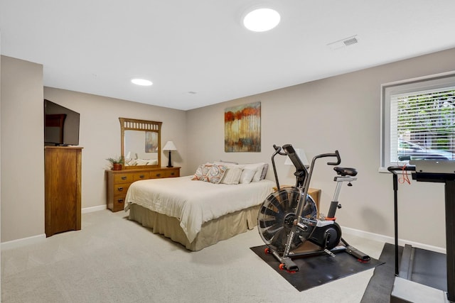 bedroom with baseboards and light carpet