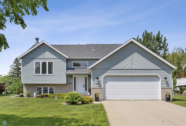 2819 33rd St S, Fargo, ND 58103 - tri-level home with brick siding, driveway, and a front lawn
