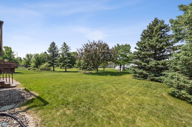 2819 33rd St S, Fargo, ND 58103 - view of green lawn with a wooden deck and stairs