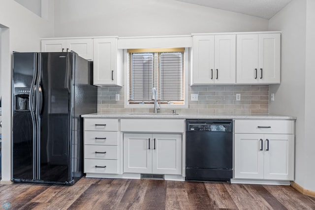 2819 33rd St S, Fargo, ND 58103 - kitchen featuring black appliances, vaulted ceiling, dark wood-type flooring, tasteful backsplash, and white cabinets