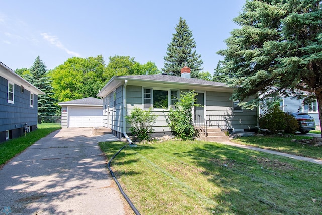 419 18th St S, Moorhead, MN 56560 - view of front of property featuring an outdoor structure, a garage, a front yard, and a chimney