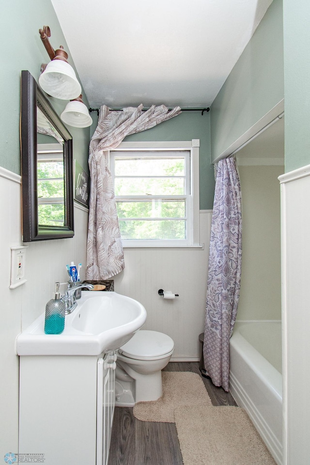 419 18th St S, Moorhead, MN 56560 - bathroom featuring vanity, wood finished floors, a wainscoted wall, and shower / bath combo