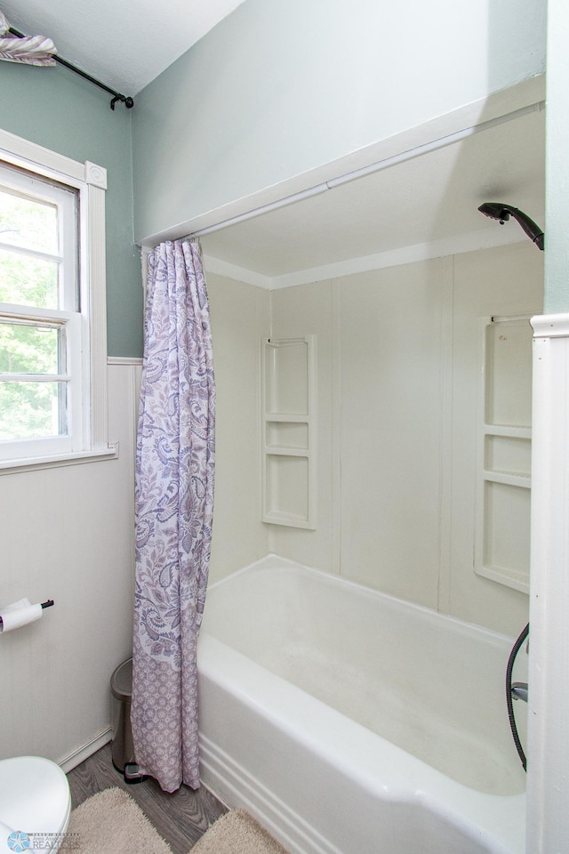 419 18th St S, Moorhead, MN 56560 - bathroom featuring shower / bath combo and wood finished floors