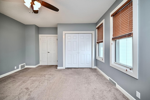 579 4th St, Winona, MN 55987 - unfurnished bedroom with carpet, multiple closets, and ceiling fan
