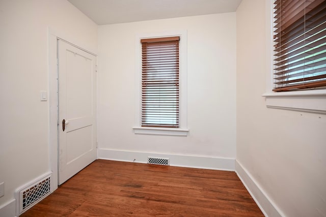 579 4th St, Winona, MN 55987 - empty room featuring healthy amount of natural light and wood finished floors