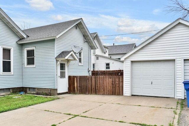 579 4th St, Winona, MN 55987 - view of property exterior with concrete driveway, a shingled roof, and a garage