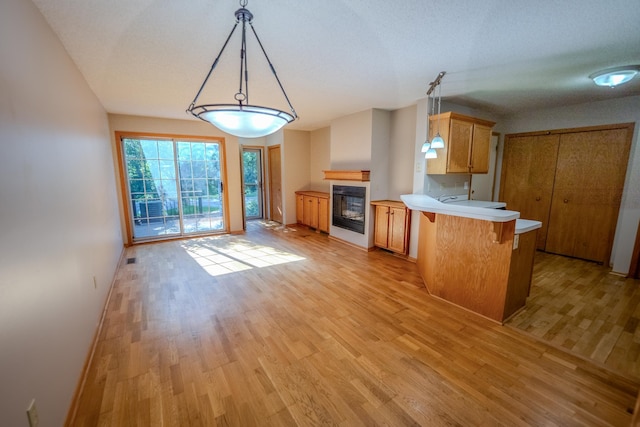 1865 Donegal Dr Unit 3, Woodbury, MN 55125 - kitchen with a peninsula, light wood-style floors, light countertops, and a breakfast bar area