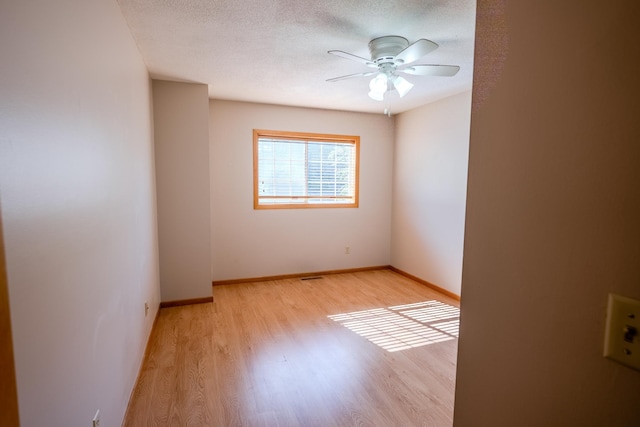 1865 Donegal Dr Unit 3, Woodbury, MN 55125 - spare room with wood finished floors, ceiling fan, and a textured ceiling