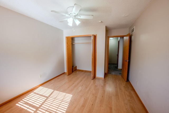 1865 Donegal Dr Unit 3, Woodbury, MN 55125 - unfurnished bedroom featuring light wood-type flooring, a closet, and a ceiling fan