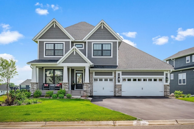 4805 Comstock Ln N, Plymouth, MN 55446 - craftsman-style home with asphalt driveway, covered porch, a front yard, and stone siding