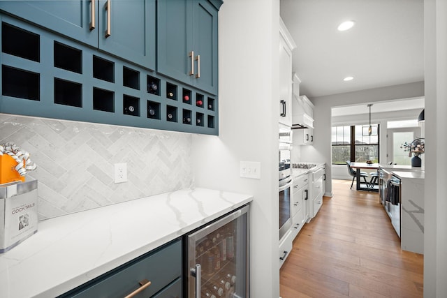 4805 Comstock Ln N, Plymouth, MN 55446 - kitchen with beverage cooler, blue cabinets, decorative backsplash, light wood-type flooring, and recessed lighting