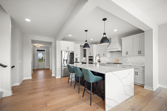 4805 Comstock Ln N, Plymouth, MN 55446 - kitchen featuring stainless steel fridge, custom exhaust hood, tasteful backsplash, a kitchen bar, and light stone counters