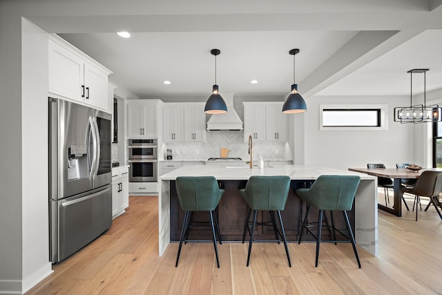 4805 Comstock Ln N, Plymouth, MN 55446 - kitchen with appliances with stainless steel finishes, wall chimney exhaust hood, tasteful backsplash, white cabinets, and light wood finished floors