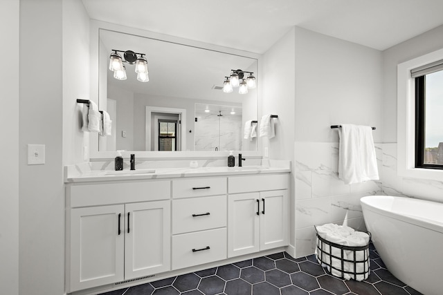 4805 Comstock Ln N, Plymouth, MN 55446 - bathroom with a marble finish shower, healthy amount of natural light, double vanity, a soaking tub, and a wainscoted wall