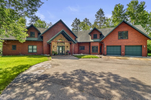 53245 Sunrise Ln, Park Rapids, MN 56470 - view of front facade with asphalt driveway, an attached garage, a front lawn, and a shingled roof