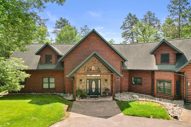 53245 Sunrise Ln, Park Rapids, MN 56470 - view of front of home with a shingled roof, a front lawn, and stone siding