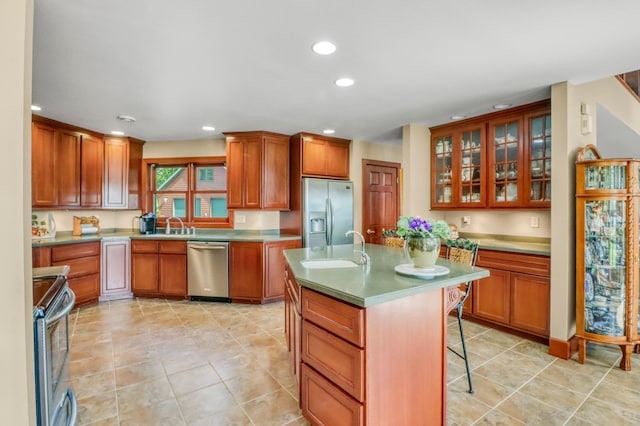 53245 Sunrise Ln, Park Rapids, MN 56470 - kitchen featuring appliances with stainless steel finishes, a breakfast bar area, recessed lighting, glass insert cabinets, and a center island with sink