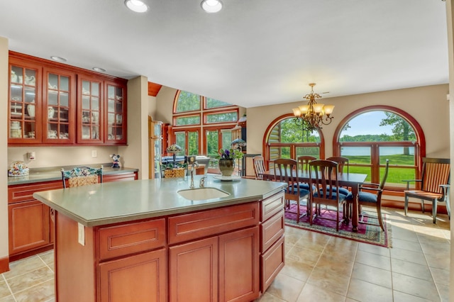 53245 Sunrise Ln, Park Rapids, MN 56470 - kitchen featuring a chandelier, a water view, recessed lighting, a center island, and glass insert cabinets