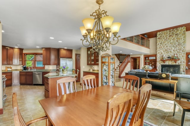53245 Sunrise Ln, Park Rapids, MN 56470 - dining room featuring stairway, a fireplace, recessed lighting, a chandelier, and light tile patterned floors