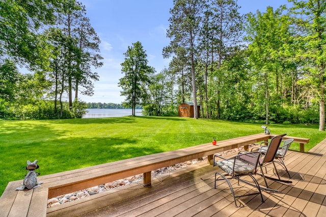 53245 Sunrise Ln, Park Rapids, MN 56470 - wooden terrace featuring a water view, a storage shed, and a yard