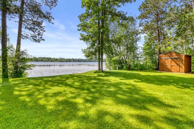 53245 Sunrise Ln, Park Rapids, MN 56470 - view of grassy yard featuring a storage unit and a water view
