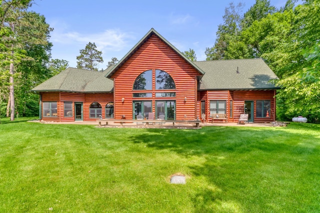 53245 Sunrise Ln, Park Rapids, MN 56470 - rear view of house with a shingled roof, a patio area, and a lawn