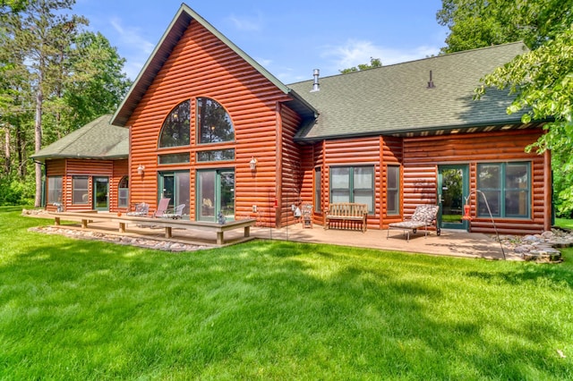 53245 Sunrise Ln, Park Rapids, MN 56470 - back of house with roof with shingles, a lawn, a patio area, and faux log siding