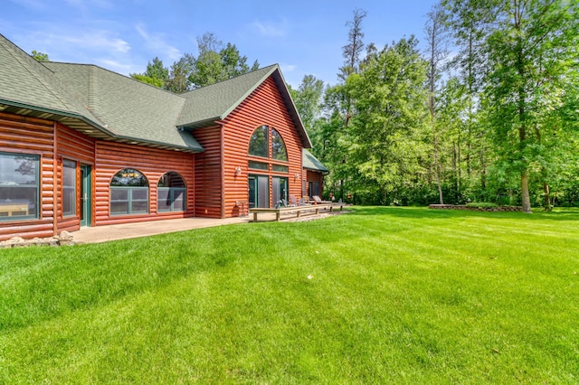 53245 Sunrise Ln, Park Rapids, MN 56470 - back of house featuring roof with shingles, a lawn, log veneer siding, and a patio