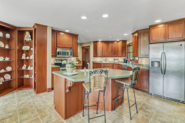 53245 Sunrise Ln, Park Rapids, MN 56470 - kitchen with stainless steel appliances, recessed lighting, a center island with sink, a kitchen breakfast bar, and light tile patterned flooring