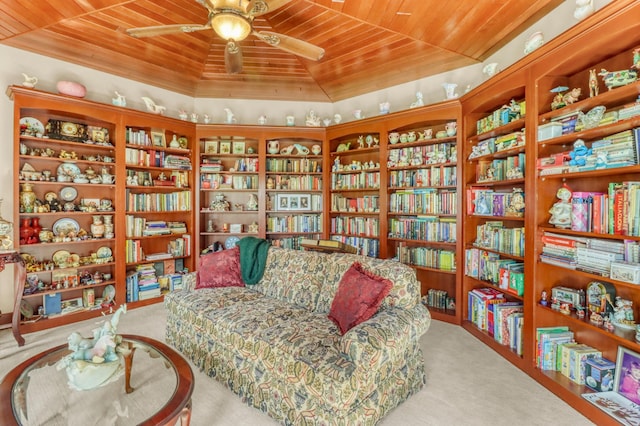 53245 Sunrise Ln, Park Rapids, MN 56470 - sitting room with wall of books, wood ceiling, carpet, and ceiling fan