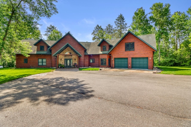 53245 Sunrise Ln, Park Rapids, MN 56470 - view of front of home with asphalt driveway, a garage, and a front yard