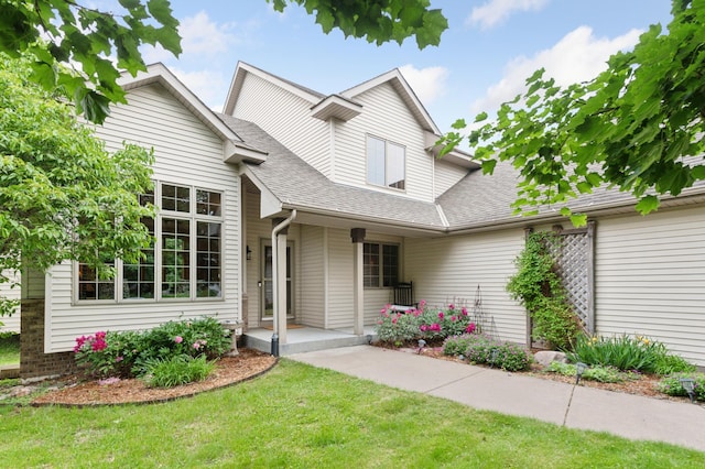 9534 Kirkwood Way N, Maple Grove, MN 55369 - traditional-style home with a front yard, a shingled roof, and covered porch