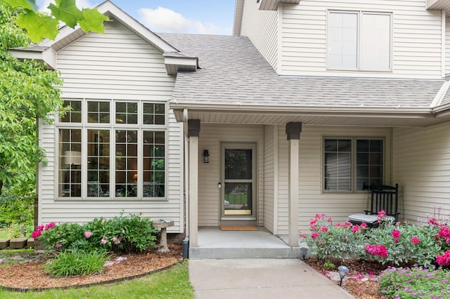 9534 Kirkwood Way N, Maple Grove, MN 55369 - view of exterior entry featuring a shingled roof and a porch