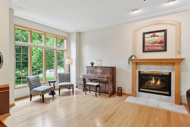9534 Kirkwood Way N, Maple Grove, MN 55369 - living area featuring hardwood / wood-style flooring, plenty of natural light, and a tile fireplace